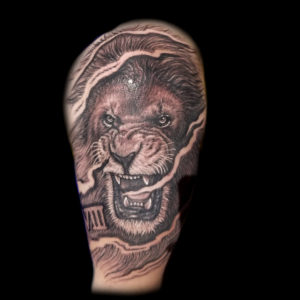 black and white realistic lion tattoo