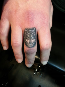 wolf finger tattoo