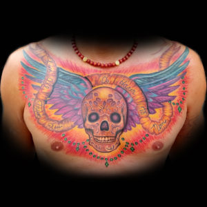skull wings chestpiece tattoo