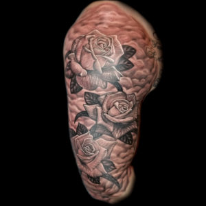 religious roses and clouds tattoo