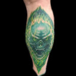 realistic skull fire green tattoo
