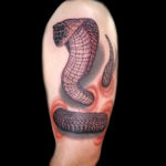 cobra snake 3d tattoo coming out of skin arm