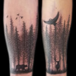 trees around forearm tattoo