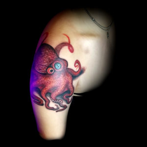 small red octopus tattoo