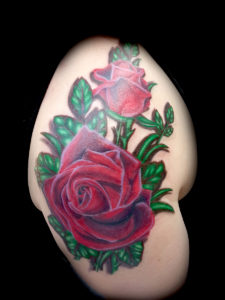 red roses arm tattoo