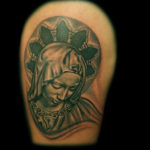 Virgin Mary sculpture tattoo